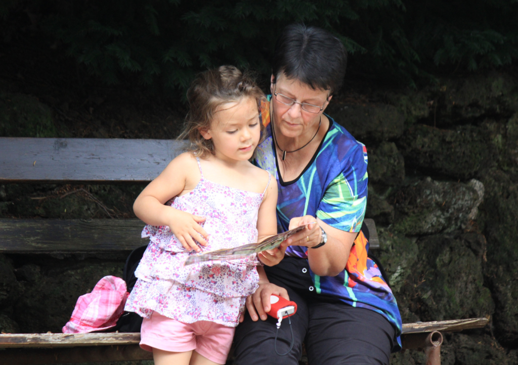 Une mémé avec sa petite fille lit un poème 